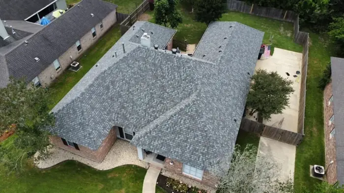 New gray roof on a ranch home with a fenced yard