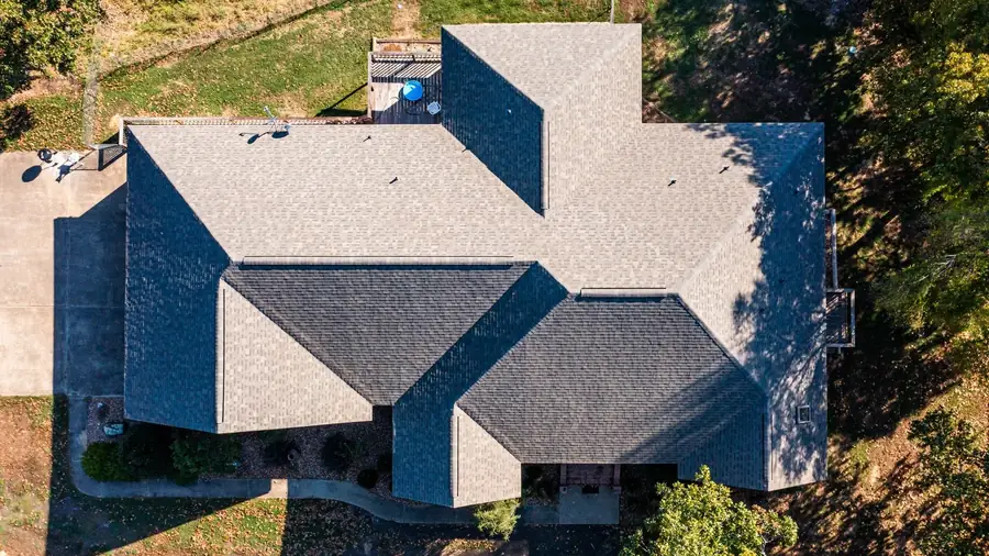 Roof replacement on a home with light and dark roof sections