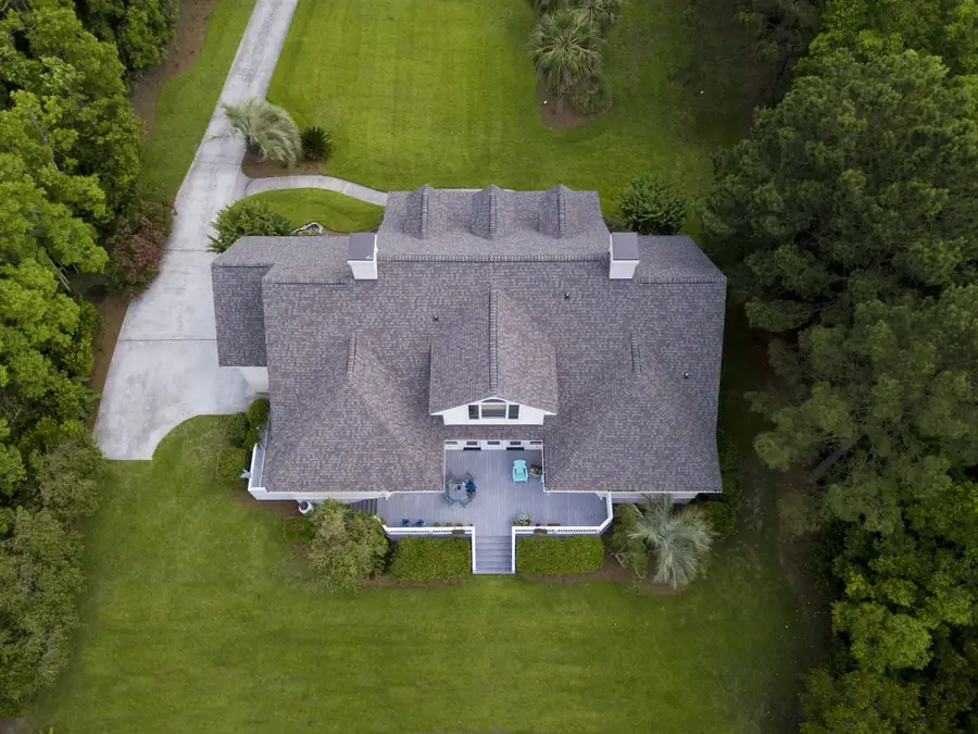 New roof on a home surrounded by trees, from above